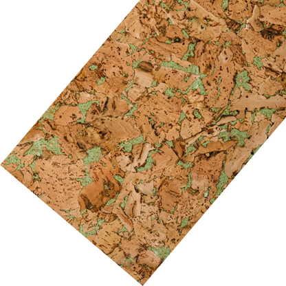 The image shows a cork tile displayed at an angle, highlighting its natural texture. It features warm brown tones with irregular green accents, creating an organic and visually interesting pattern.